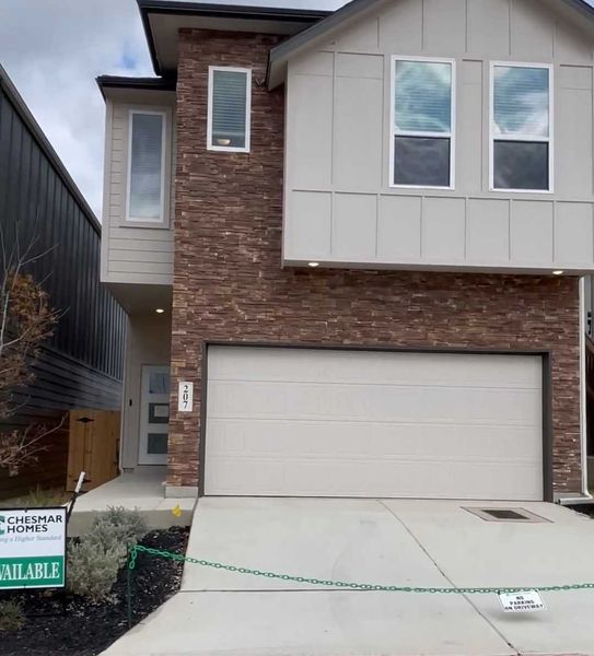 A contemporary brick-accented home with a sleek facade in Rose Hill by Chesmar Homes (San Antonio, TX). A contemporary brick-accented home with a sleek facade in Rose Hill by Chesmar Homes (San Antonio, TX).