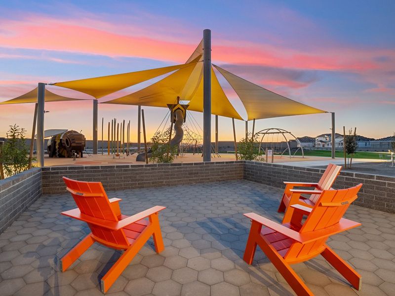 A patio with chairs and an umbrella.