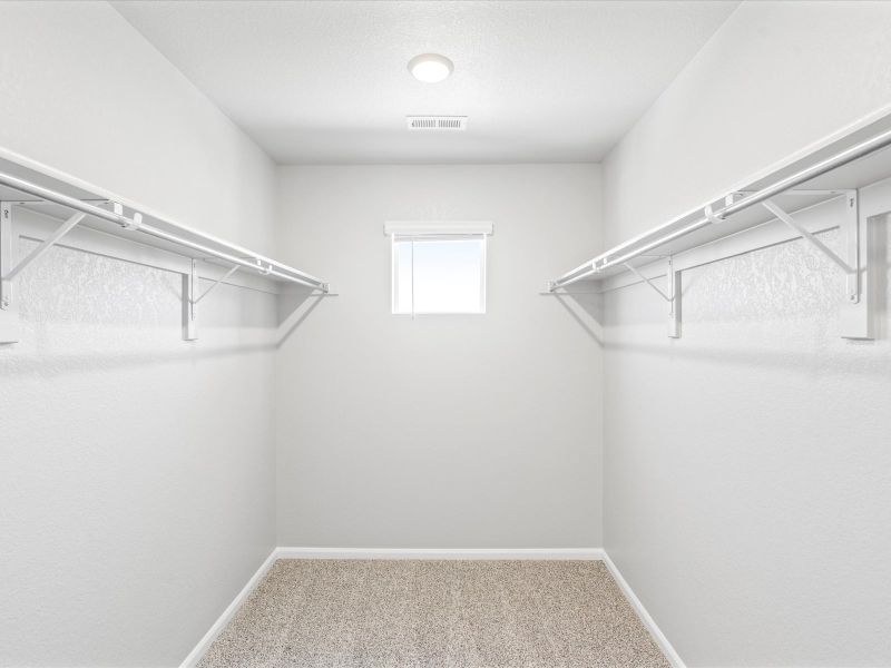 Primary closet in the Woodland floorplan at a Meritage Homes community in Broomfield, CO.