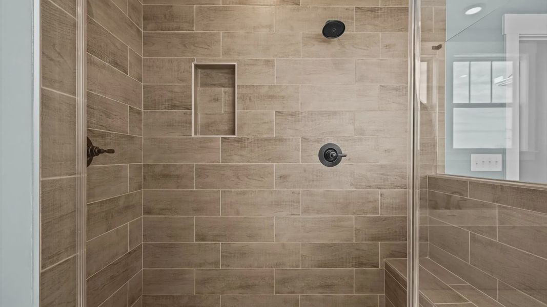 New two story home with large primary bathroom with tiled walk in shower at Pinebrook by DRB Homes in Woodruff, SC New two story home with large primary bathroom with tiled walk in shower at Pinebrook by DRB Homes in Woodruff, SC