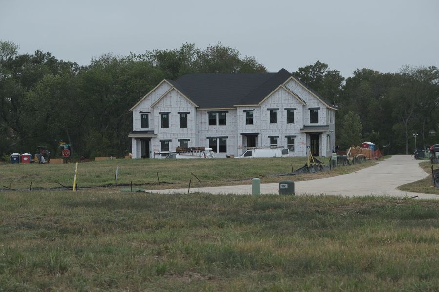 Front exterior of a home in the Painted Tree - Village District community, located in McKinney, TX (Image 3). Front exterior of a home in the Painted Tree - Village District community, located in McKinney, TX (Image 3).