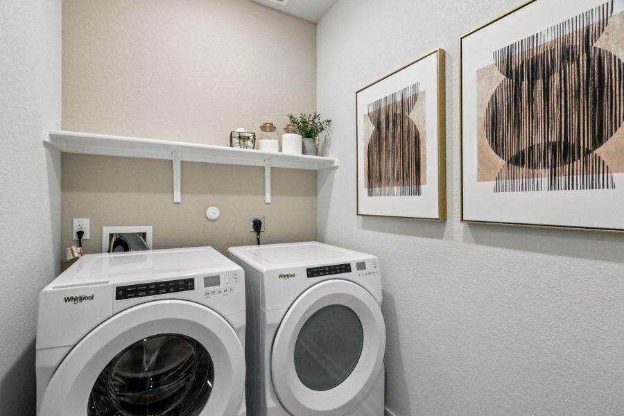 A washing machine and dryer in a room. A washing machine and dryer in a room.
