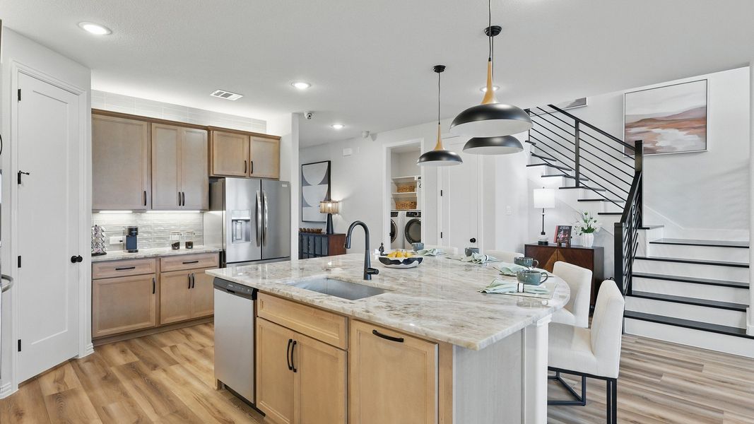 Luxurious Westridge kitchen with exquisite marble island, sophisticated pendant lighting, and elegant wooden cabinetry.