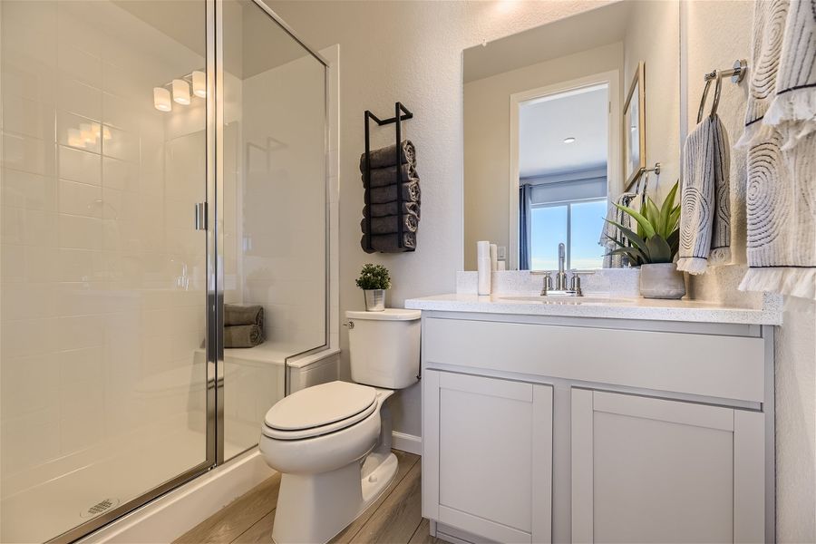 A bathroom with a shower and toilet.