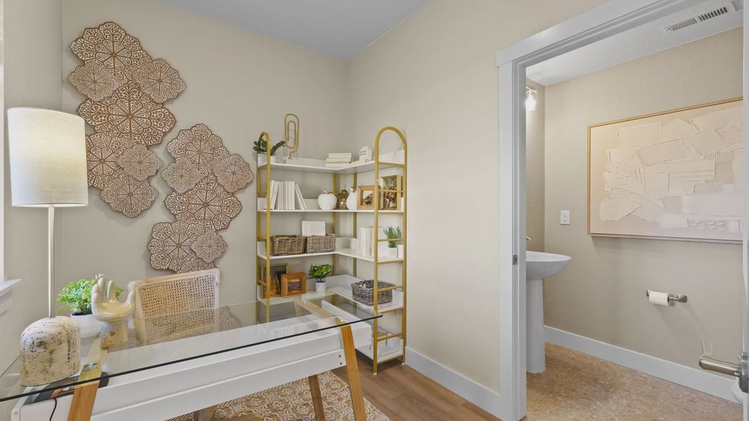 Explore this chic Dillon Pointe office featuring a glass desk, gold shelving, and intricate wall art. Explore this chic Dillon Pointe office featuring a glass desk, gold shelving, and intricate wall art.