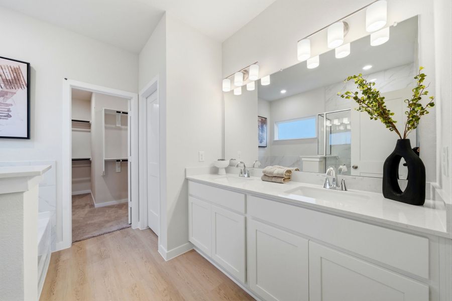 A bathroom with white cabinets. A bathroom with white cabinets.