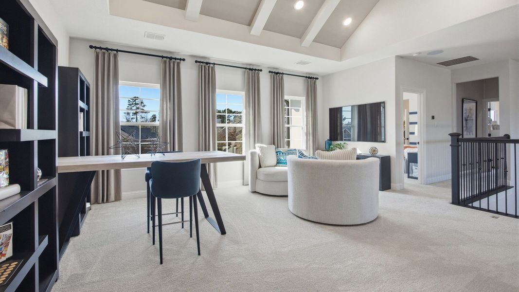 Sophisticated vaulted ceiling and vibrant blue drapery define this chic space in Mostyn Manor Reserve, Texas.