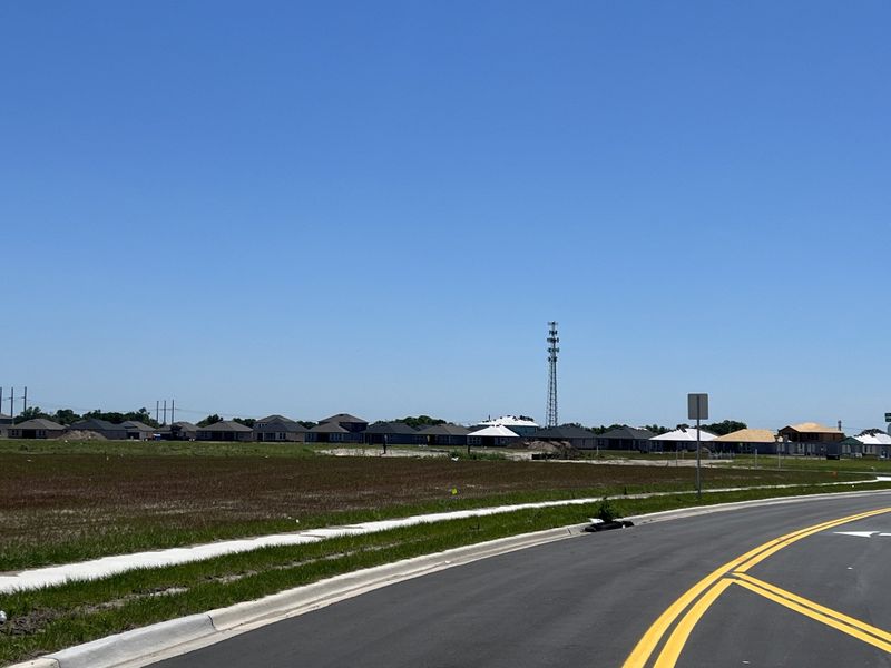 A developing neighborhood with new homes and open green spaces in Stonegate Preserve: The Executives by Lennar (Palmetto, FL).