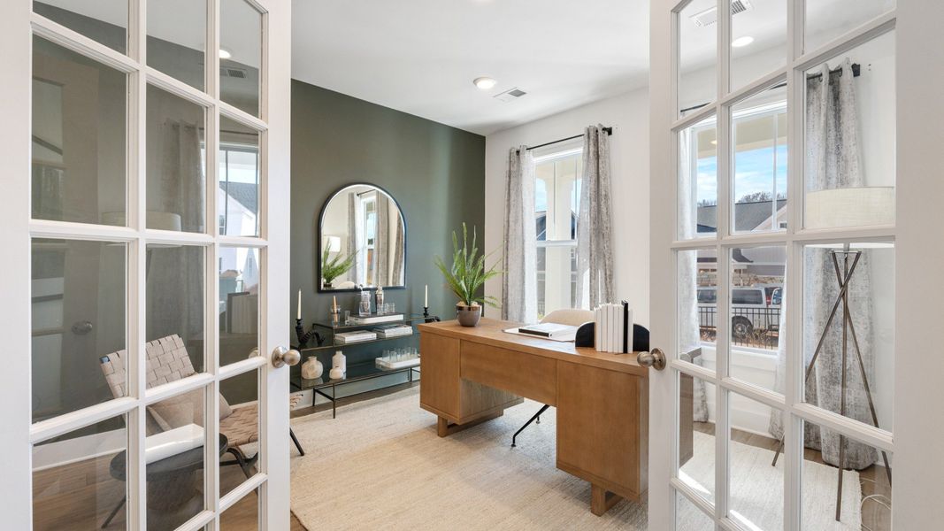 Vibrant natural light and tasteful design define this French door study near the front of the home Vibrant natural light and tasteful design define this French door study near the front of the home