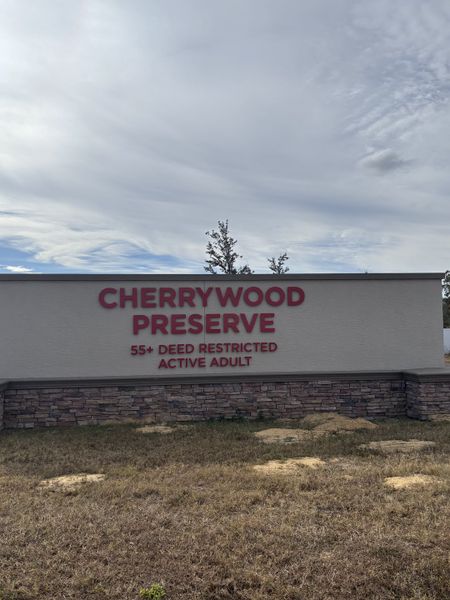 A welcoming sign marks Cherrywood Preserve by Casa Fresca Homes in Ocala, FL, for active adults 55+ in a peaceful setting.
