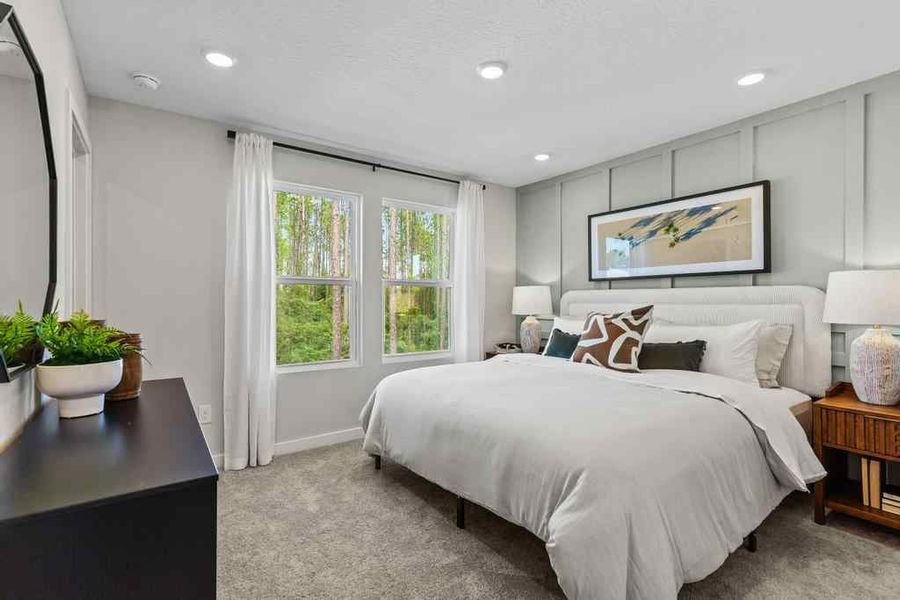 A bedroom with a bed and a table. A bedroom with a bed and a table.