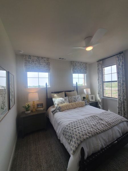 A cozy bedroom featuring elegant patterned curtains, a plush bed with decorative pillows, and soft lighting for a restful ambiance. A cozy bedroom featuring elegant patterned curtains, a plush bed with decorative pillows, and soft lighting for a restful ambiance.