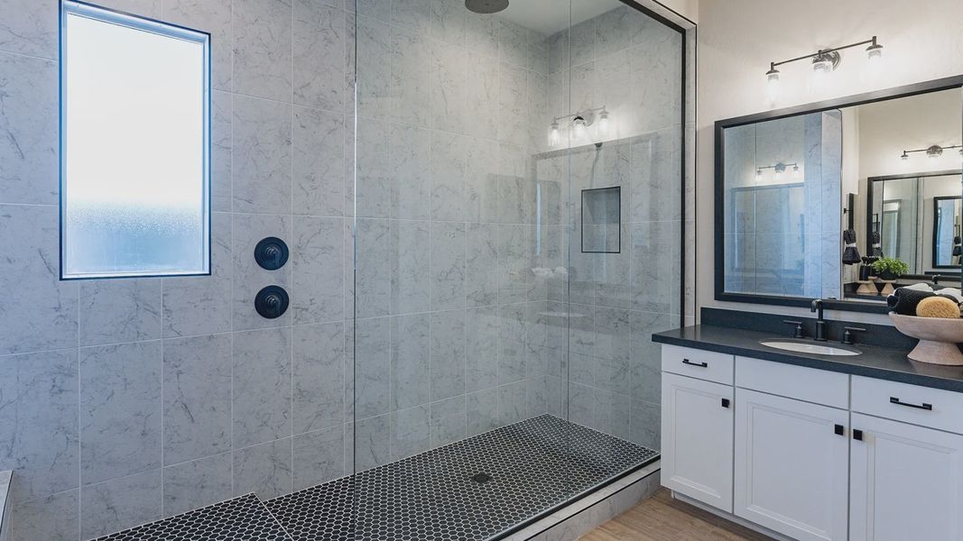 Experience opulence with marble shower tiles, sleek glass, and high-end black fixtures in Arroyo Seco. Experience opulence with marble shower tiles, sleek glass, and high-end black fixtures in Arroyo Seco.