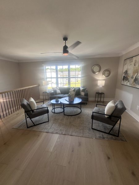 A bright living area with modern seating, contemporary decor, and light wood flooring, highlighted by sleek ceiling lighting. A bright living area with modern seating, contemporary decor, and light wood flooring, highlighted by sleek ceiling lighting.