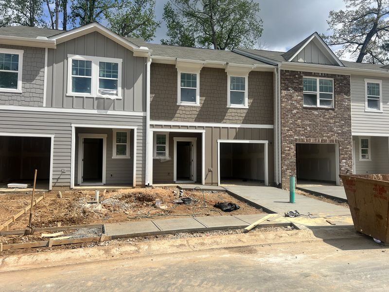 Modern townhouses with varied textures and garages in Aviary Park by Starlight Homes (Atlanta, GA).