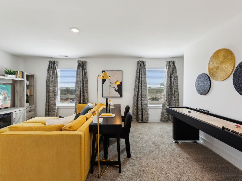 The bonus room offers a place for the kids to work on homework.