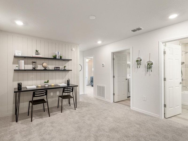 Upstairs, a loft provides desirable flexible-use space - Flora townhome by Highland Homes