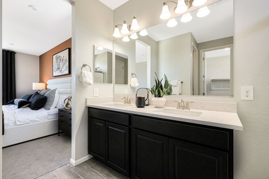 A bathroom with a sink and a bed. A bathroom with a sink and a bed.