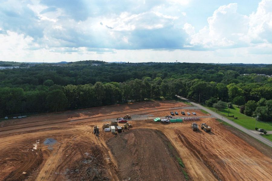 A dirt road with cars on it. A dirt road with cars on it.