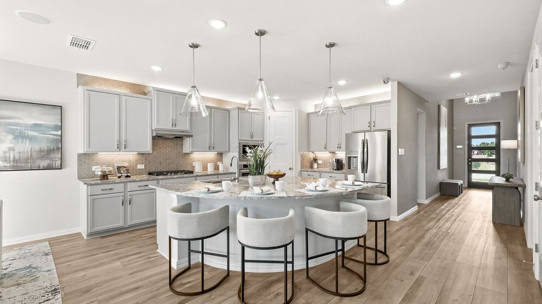 Marvel at the marble island, chic cabinetry, and exquisite pendant lighting in Green Oaks Preserve. Marvel at the marble island, chic cabinetry, and exquisite pendant lighting in Green Oaks Preserve.