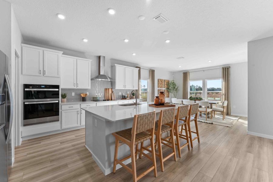 A kitchen with a dining table and chairs. A kitchen with a dining table and chairs.