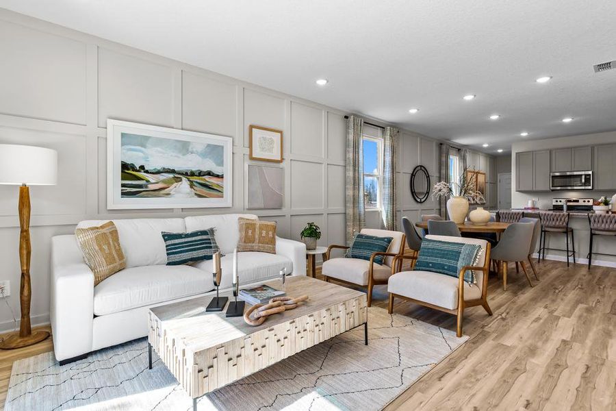 A living room with a large rug and a couch. A living room with a large rug and a couch.