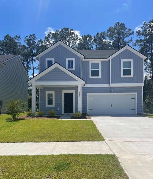 A charming blue two-story home with a spacious front yard in Cypress Preserve: Arbor Collection by Lennar (Moncks Corner, SC).