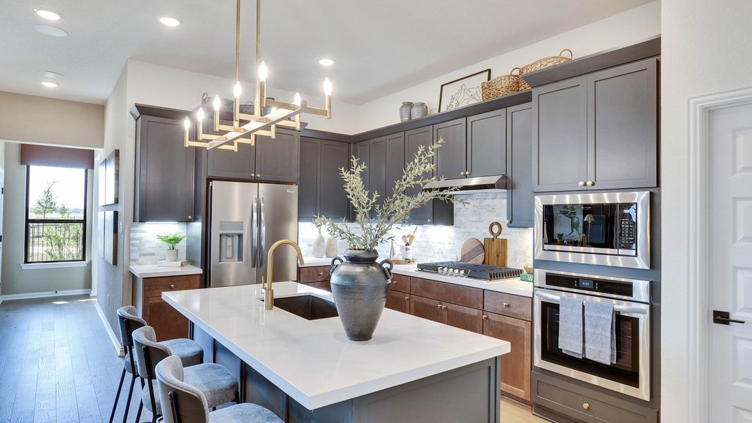 Elegant cabinetry and sleek island elevate this Lakeside Meadows kitchen's sophisticated charm. Elegant cabinetry and sleek island elevate this Lakeside Meadows kitchen's sophisticated charm.
