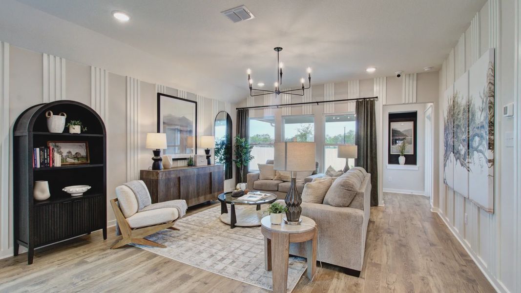 Experience refined living with wood flooring, stylish chandelier, and ample natural light in Prairie Green.