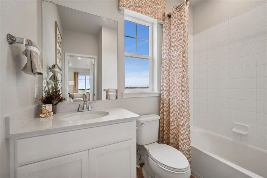 A bathroom with a tub sink and toilet. A bathroom with a tub sink and toilet.