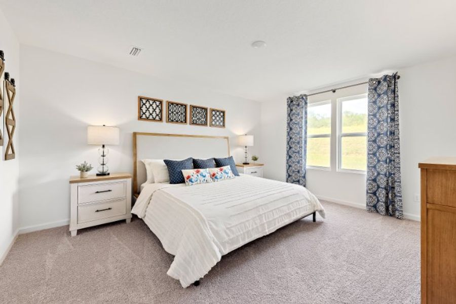 A bedroom with a bed and a window. A bedroom with a bed and a window.