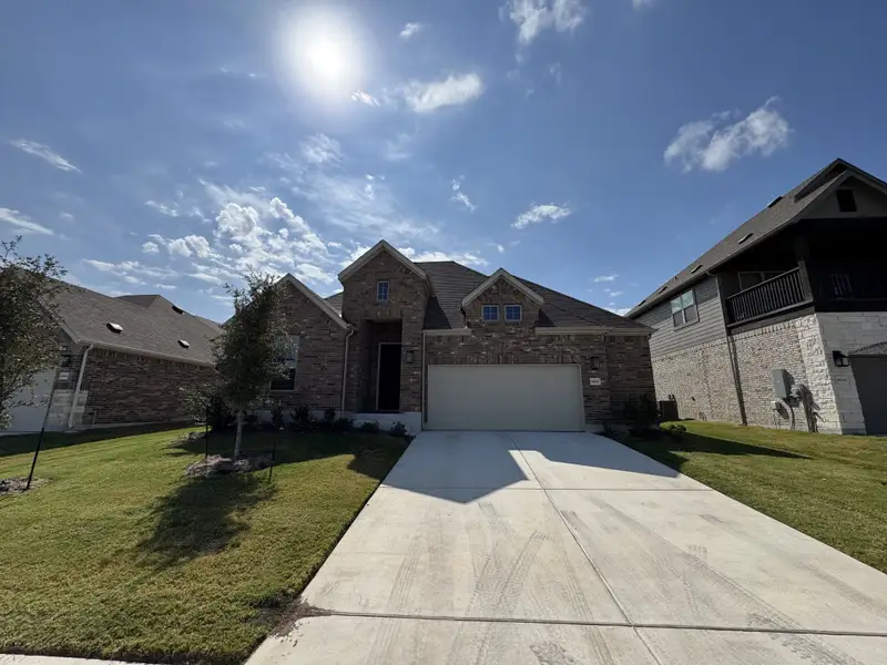 A beautiful brick home with a spacious driveway in Highlands North by Brightland Homes (Hutto, TX). A beautiful brick home with a spacious driveway in Highlands North by Brightland Homes (Hutto, TX).