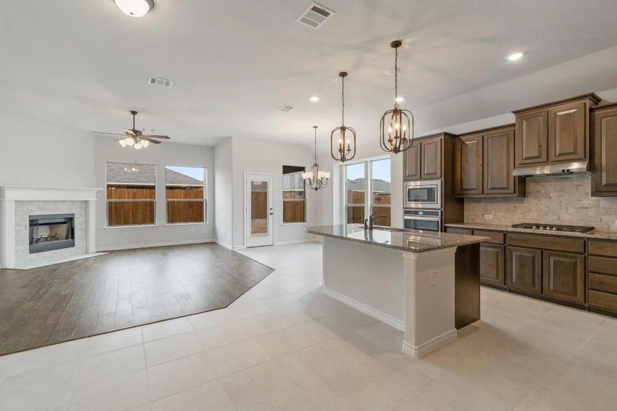 Kitchen & Family Room | Concept 1841 at Coyote Crossing in Godley, TX by Landsea Homes