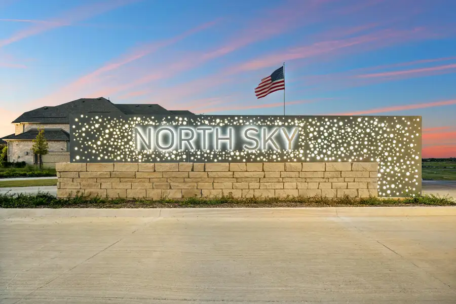 North Sky community entry sign lit up at night