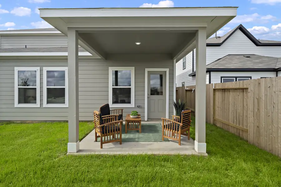 A house with a deck and chairs.