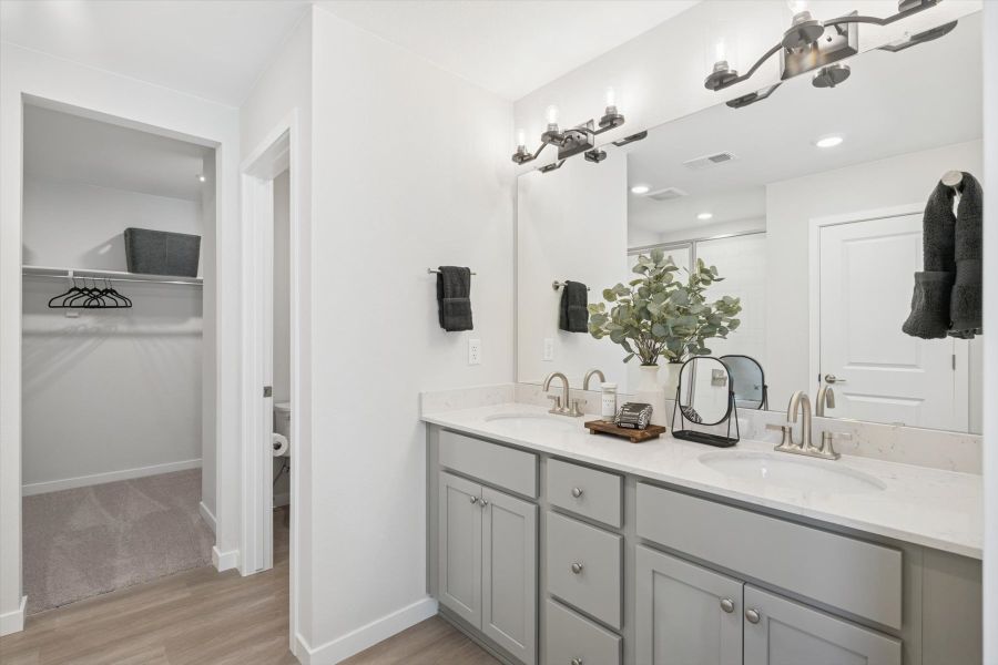 A bathroom with a large mirror.