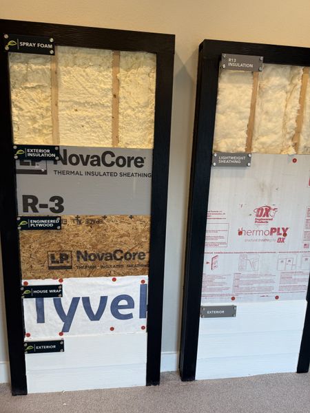 A detailed view of wall insulation materials, showcasing spray foam and thermal sheathing. A detailed view of wall insulation materials, showcasing spray foam and thermal sheathing.