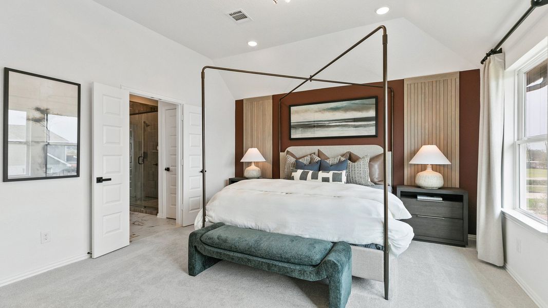 Elegant four-poster bed and modern lighting create a chic ambiance in this Park at Eldridge bedroom.