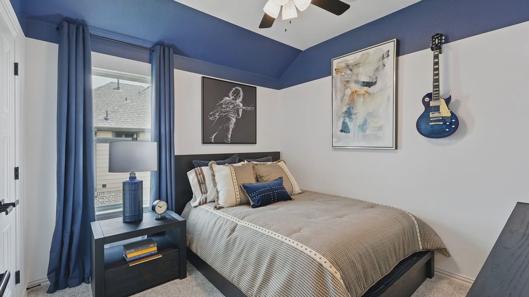 Westridge's bedroom boasts luxury with modern wall art and chic blue decor.