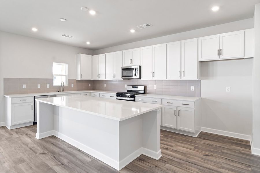 A kitchen with white cabinets. A kitchen with white cabinets.