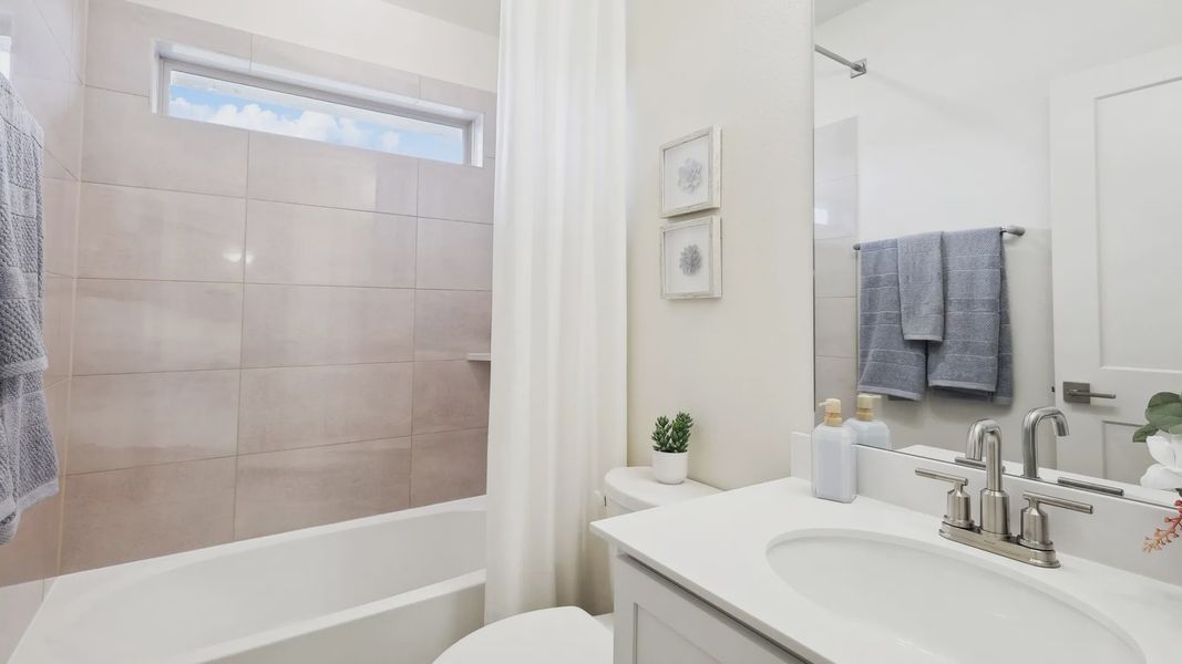 Experience refined elegance with minimalist decor and soft beige tiles in The Oaks’ bathroom.