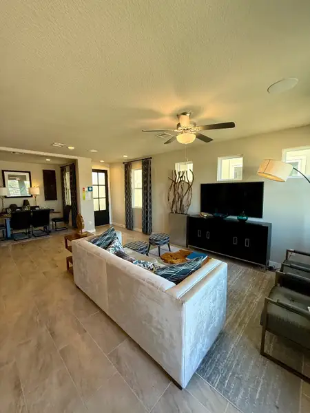 A contemporary living room featuring elegant seating, wood accents, and natural light highlighting modern decor elements.