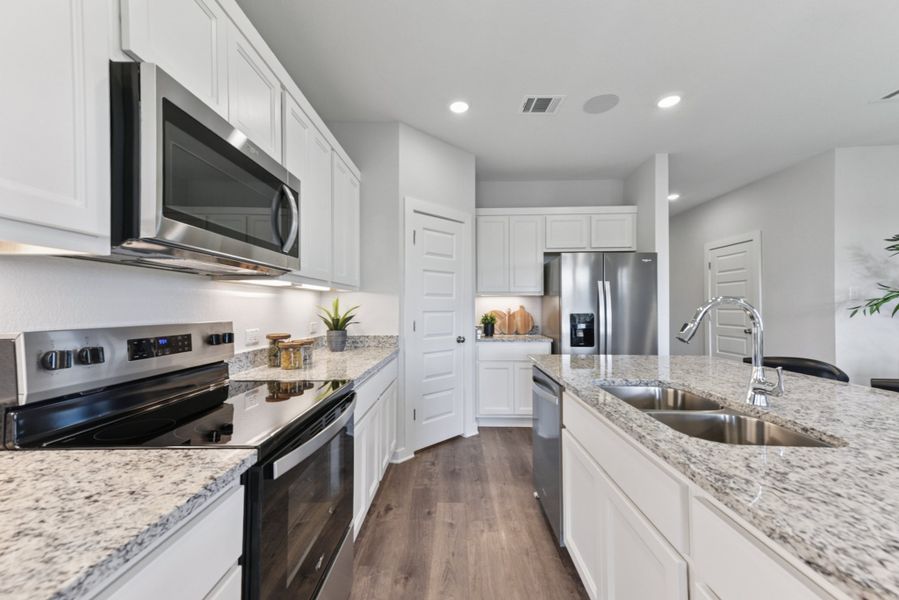A kitchen with white cabinets. A kitchen with white cabinets.