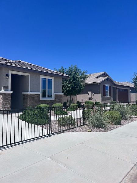 A charming modern home with manicured landscaping in The Views at Rancho Cabrillo by Scott Communities (Peoria, AZ).