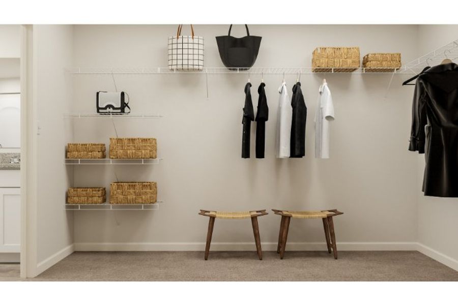 A room with a wall of clothes on the wall.