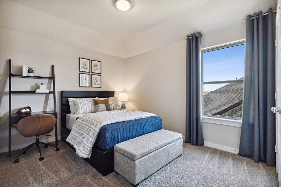 Bedroom in an Oak Model Home by Trophy Signature Homes