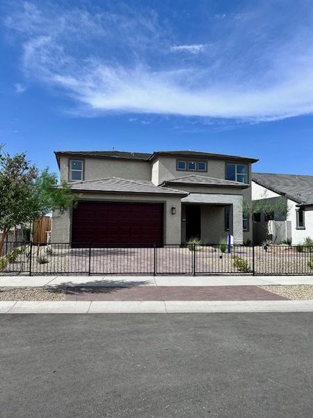 A modern two-story home with a sleek design in The Grove at El Cidro by William Ryan Homes (Goodyear, AZ).