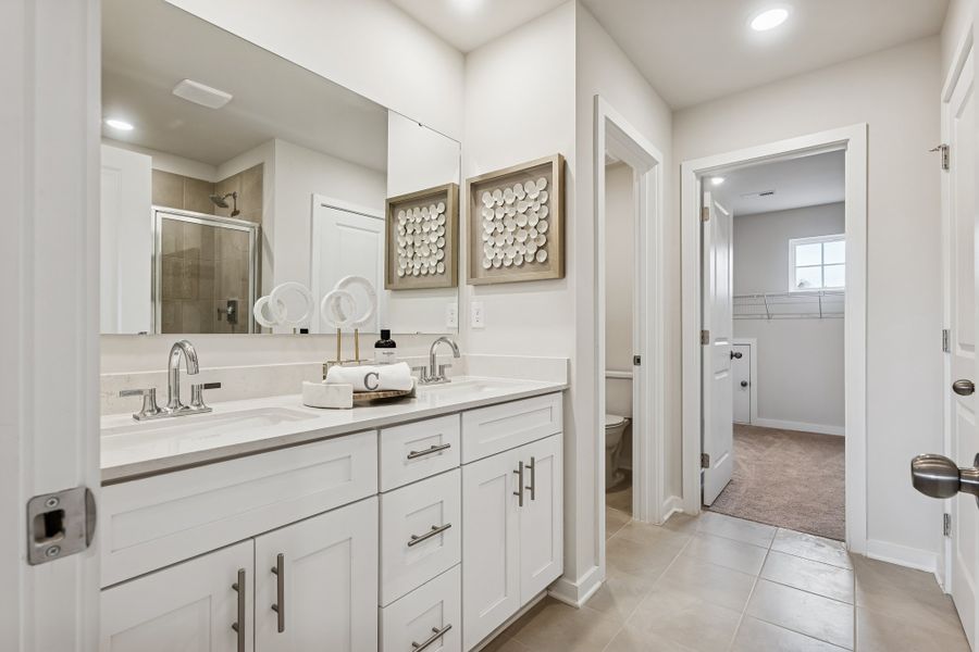 A bathroom with white cabinets. A bathroom with white cabinets.