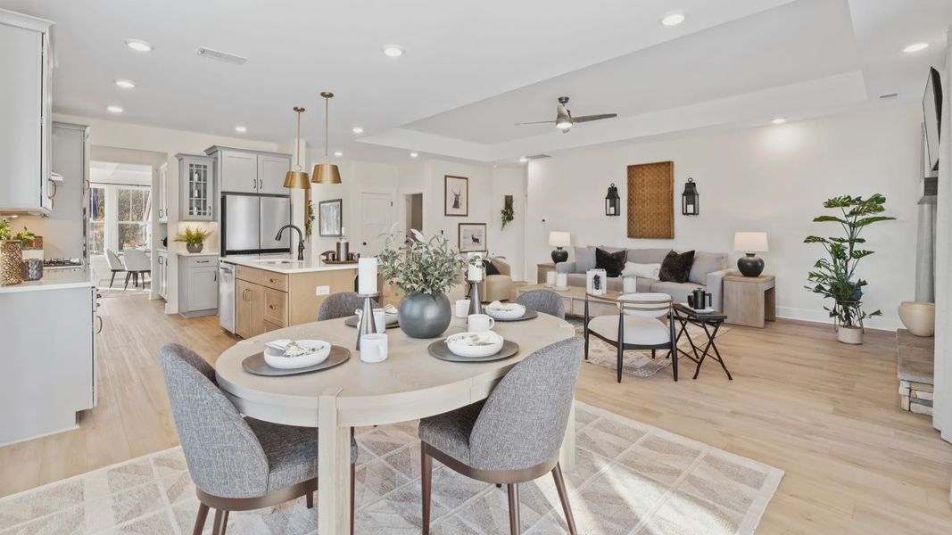 Modern farmhouse breakfast area adjacent from the kitchen and family room in open concept first floor living spaces