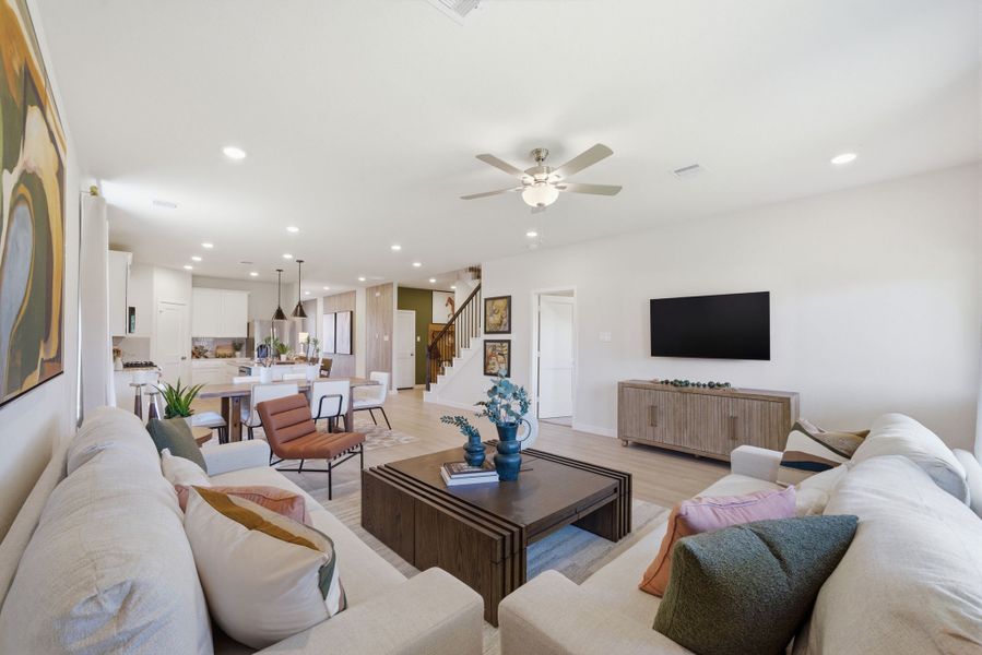 A living room with a tv and couches. A living room with a tv and couches.